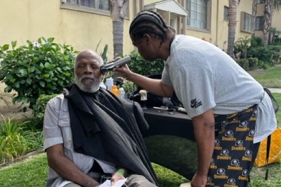 barber grooming older man